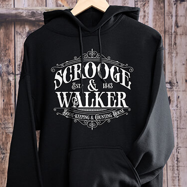 A personalized Scrooge hoodie laid against a wooden background