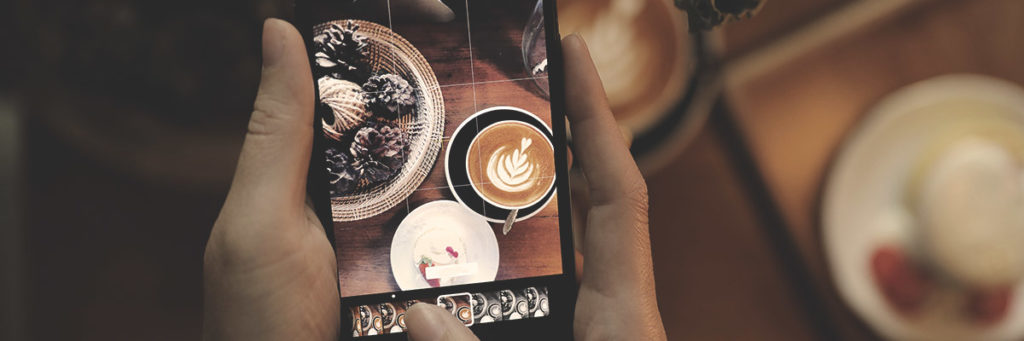 A person snapping some shots of coffee and decorative items.