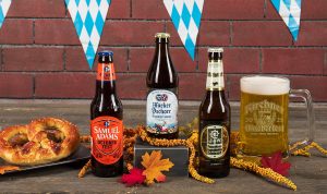 Bottles of Augustiner, Hacker-Pschorr, and Sam Adams in an Oktoberfest spread